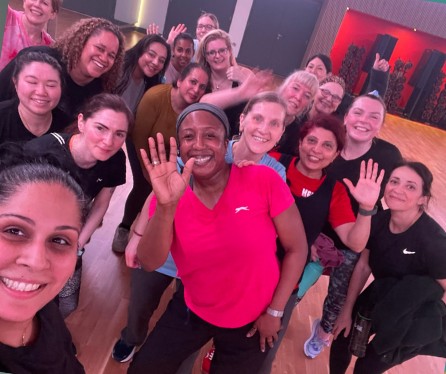 Medina with a smiling group of class members after a session