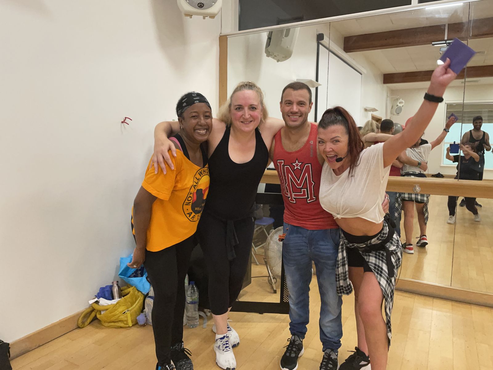Medina Jordan, in a yellow top, celebrating with fellow dancers after a class