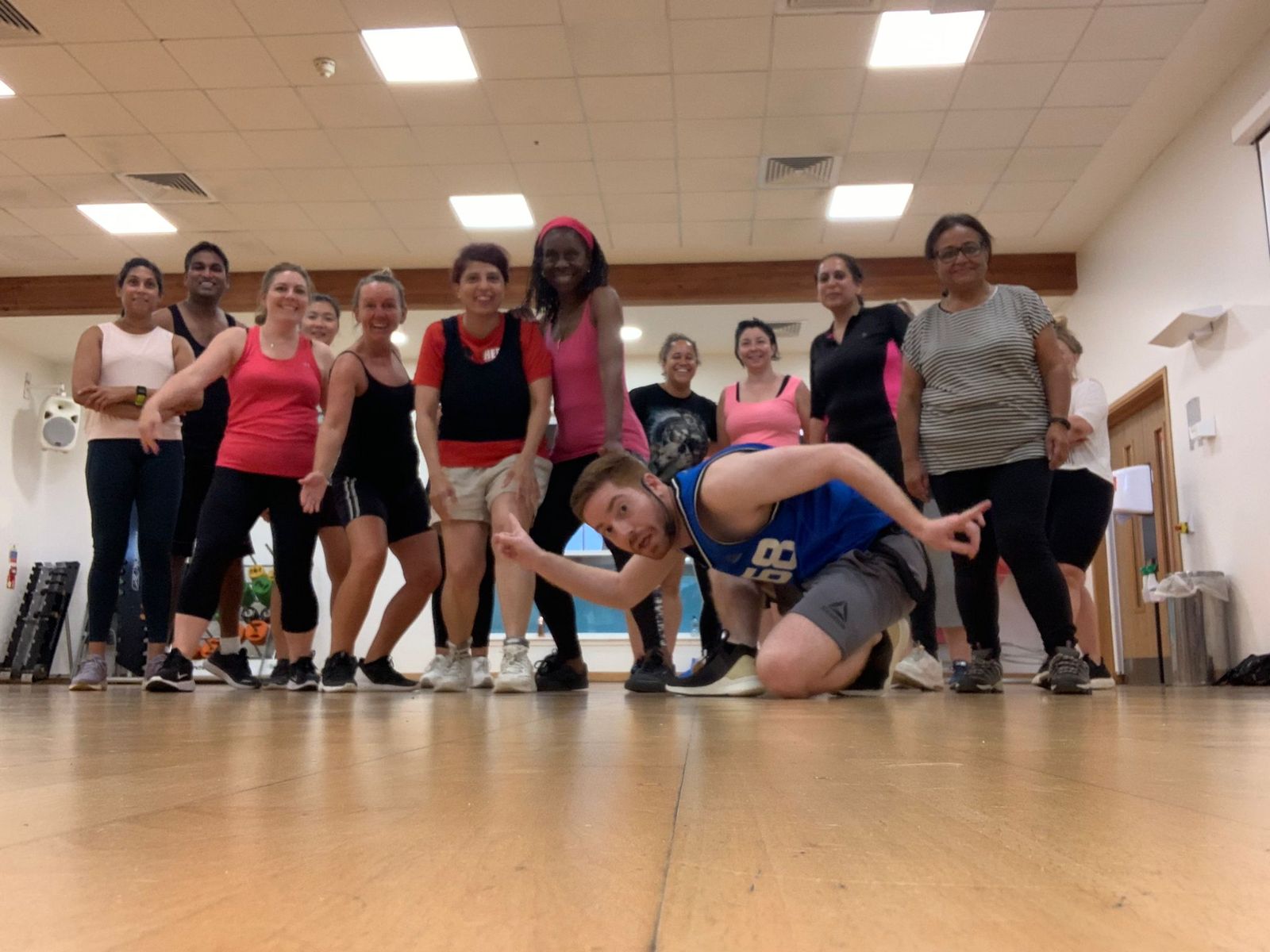 Class members striking a dance pose together