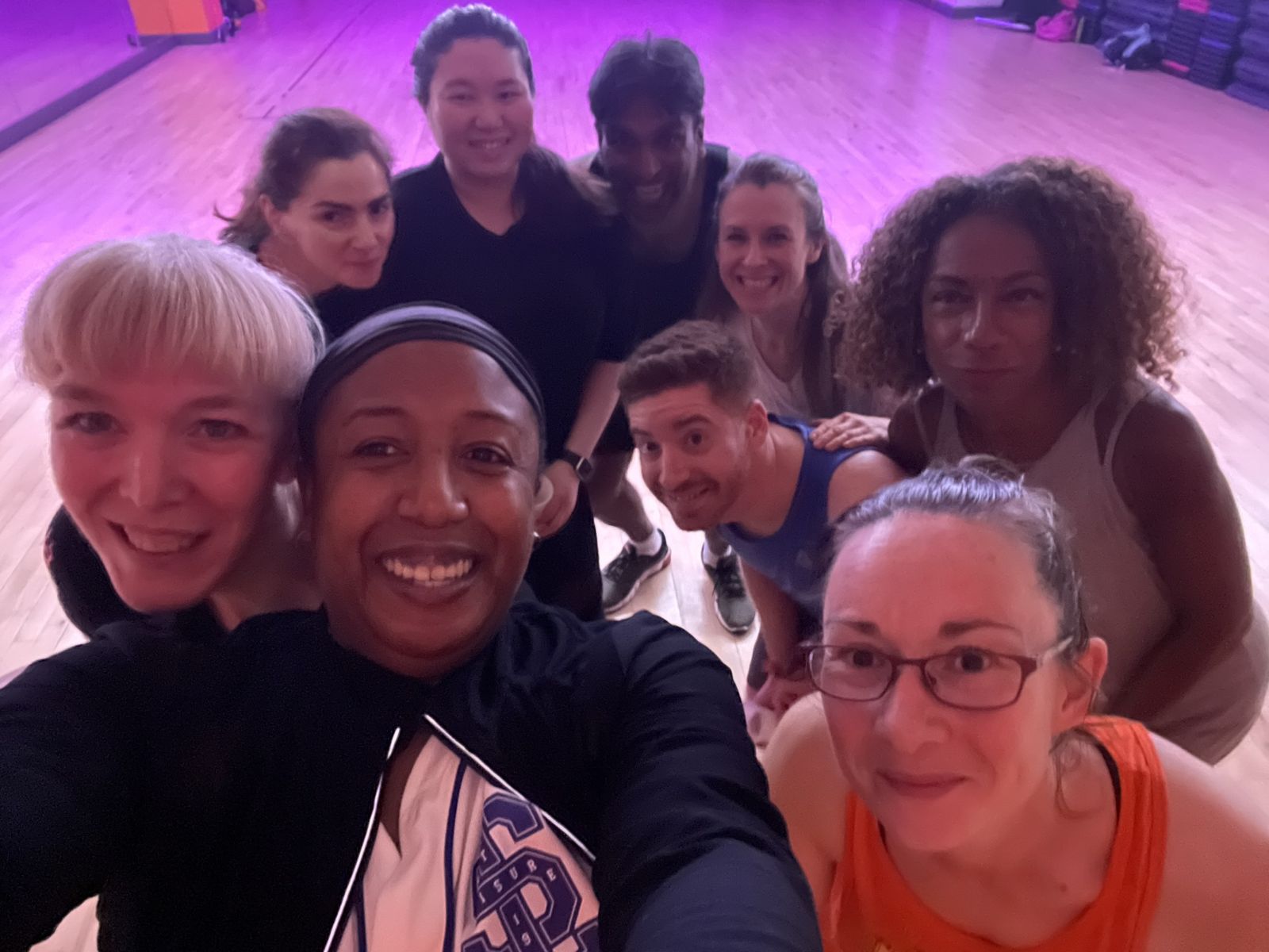 Selfie of Medina with class members in a studio with purple lighting